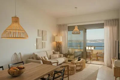 a living room with a couch and a table at Ocean Bay Sea View Apartment, Pool, Brand New, 2B in Kalyves