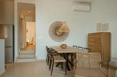 a kitchen and dining room with a table and chairs at Ocean Bay Sea View Apartment, Pool, Brand New, 2B in Kalyves