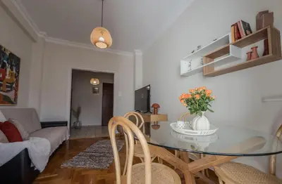 a living room with a glass table and chairs at Sunny Nest, Stylish & Bright Urban Retreat in Chania Town