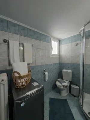 a bathroom with a sink and a toilet and a shower at Sunny Nest, Stylish & Bright Urban Retreat in Chania Town
