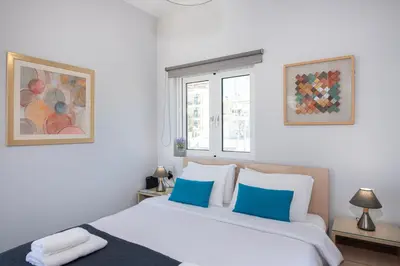 two beds in a room with white and blue at Stelios Florans Apartment in Chania Town