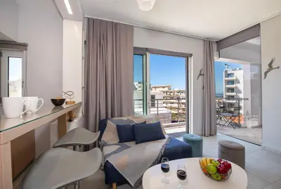 a living room with a couch and a table at Stelios Florans Apartment in Chania Town