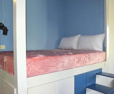 a bed in a blue room with a pink blanket at Modern Central Apartment - 400m to Beach in Kissamos