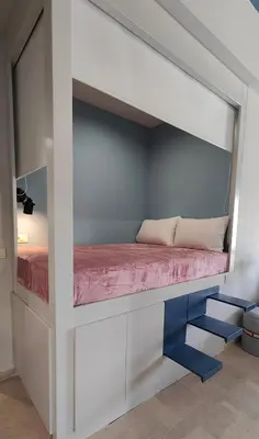 a bed in a loft bed room with a bed underneath it at Modern Central Apartment - 400m to Beach in Kissamos