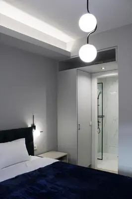 a bedroom with a bed and a walk in shower at Modern Central Apartment - 400m to Beach in Kissamos