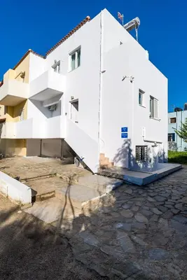 a white building with a shadow of a tree at Almyrida Bayview VII - BY APOKORONAS VILLAS in Almirida