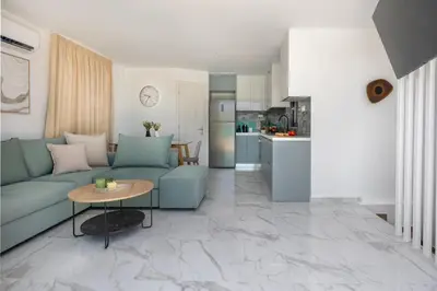 a living room with a blue couch and a table at Villa Metochi with Private Pool in Palio Gerani
