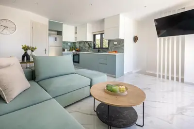 a living room with a couch and a table at Villa Metochi with Private Pool in Palio Gerani