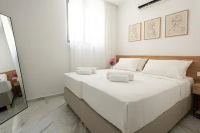a bedroom with a large white bed with towels on it at Villa Metochi with Private Pool in Palio Gerani
