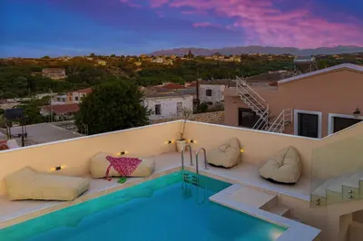 a villa with a swimming pool at dusk at Villa Metochi with Private Pool in Palio Gerani