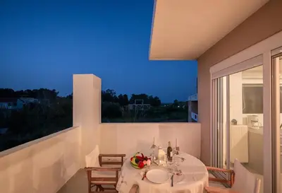 a dining room with a table and a large window at Villa Joy Mare - Seaside Escape with Private Pool in Aghii Apostoli