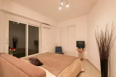 a bedroom with a bed and a tv in it at Villa Joy Mare - Seaside Escape with Private Pool in Aghii Apostoli