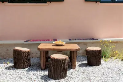 a wooden table and two logs with a bowl on it at 5-bedroom Country House in Crete - Olive Grove Retreat in Nerokhórion