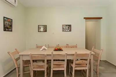 a dining room with a table and chairs at 5-bedroom Country House in Crete - Olive Grove Retreat in Nerokhórion