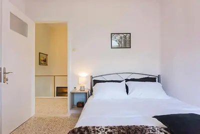 a bedroom with a bed with a white bedspread at 5-bedroom Country House in Crete - Olive Grove Retreat in Nerokhórion