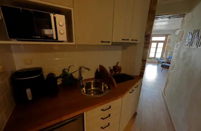 a kitchen with a sink and a microwave at Vecia Abasia - The Old Abbey in Chania Town