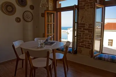 a dining room with a table with a laptop on it at Vecia Abasia - The Old Abbey in Chania Town