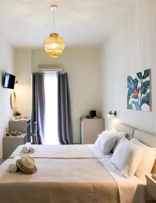 a bedroom with a large bed with a chandelier at stelisia2 in Chania Town