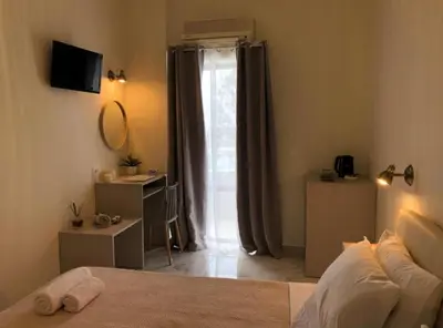 a bedroom with a bed and a large window at stelisia2 in Chania Town