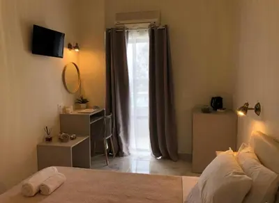 a bedroom with a bed and a door with a window at stelisia2 in Chania Town