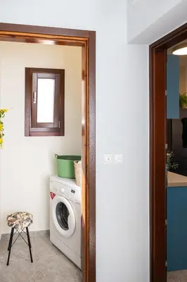 a laundry room with a washer and dryer at 3 Sails - 2BR on Venetian Harbour with Balcony in Chania Town