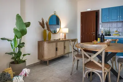 a dining room with a table and a mirror at 3 Sails - 2BR on Venetian Harbour with Balcony in Chania Town
