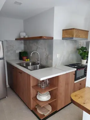a kitchen with a sink and a stove at Vrahakia Apartment 1 in Marina Galatas in Galatás