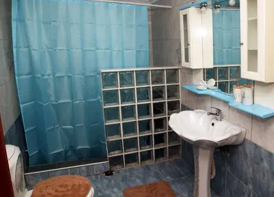 a bathroom with a sink and a shower at Komvos Apartment in Souda