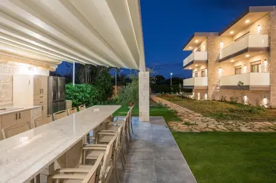 a large outdoor bar with benches in front of a building at Armdin Seaview Villa 1 in Módhion