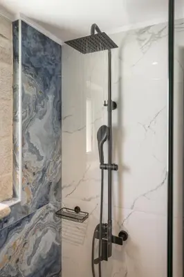 a shower with a glass door in a bathroom at Armdin Seaview Villa 1 in Módhion