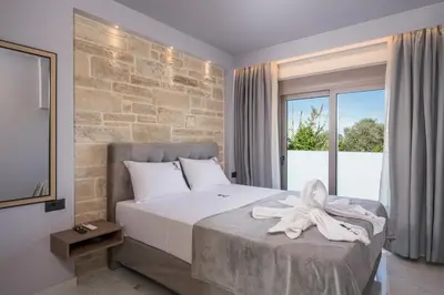 a bedroom with a bed with a towel on it at Armdin Seaview Villa 2 in Módhion