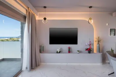 a living room with a flat screen tv on a wall at Armdin Seaview Villa 2 in Módhion