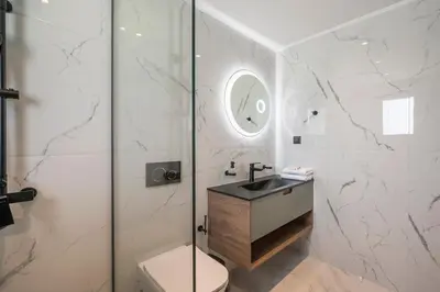 a bathroom with a toilet and a sink and a shower at Armdin Seaview Villa 3 in Módhion