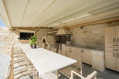 a kitchen with a white table and chairs at Armdin Seaview Villa 3 in Módhion
