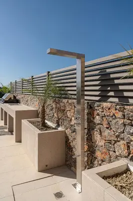 a stone wall with a row of benches at Casa Viento in Ravdhoúkha