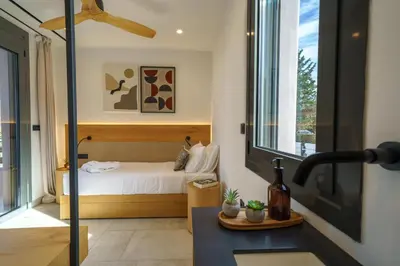 a bedroom with a bed and a sink in a room at EAST VILLA by CYAMES in Gavalochori