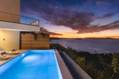 a swimming pool in a house with a view of the ocean at BelSodi - 3bedroom sea views and heated pool in Chania Town
