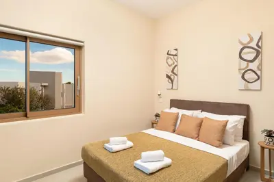 a bedroom with a bed with two towels on it at BelSodi - 3bedroom sea views and heated pool in Chania Town