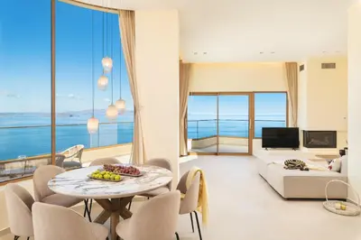 a living room with a table and a couch at BelSodi - 3bedroom sea views and heated pool in Chania Town