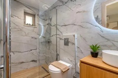 a bathroom with a shower and a toilet and a sink at Victoria Luxury Residence in Kissamos