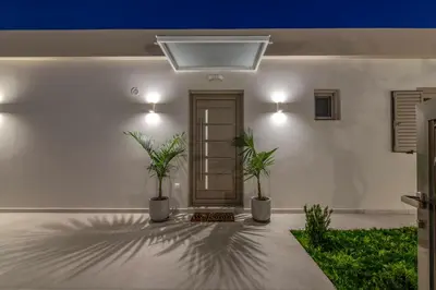 a room with two potted plants in front of a door at Victoria Luxury Residence in Kissamos
