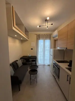 a kitchen and living room with a couch and a table at NESTIVA - Apartment in the Center of Chania in Chania Town