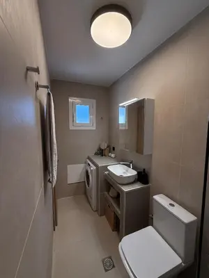 a bathroom with a sink and a washing machine at NESTIVA - Apartment in the Center of Chania in Chania Town