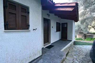 a house with a door on the side of it at Chania Hillside 2BD Home - Nature & Comfort by ΜΡS