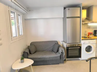 a small living room with a couch and a kitchen at Cozy Apartment with Private Jacuzzi - Fiber Internet - Private Parking in Chania Town
