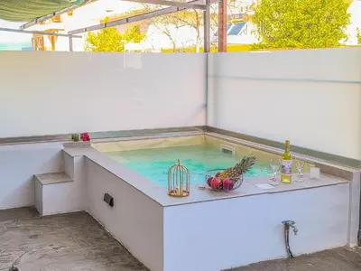 a hot tub with a bird cage in the water at Cozy Apartment with Private Jacuzzi - Fiber Internet - Private Parking in Chania Town