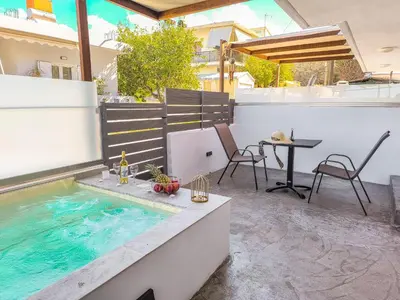 a pool on a patio with a table and chairs at Cozy Apartment with Private Jacuzzi - Fiber Internet - Private Parking in Chania Town