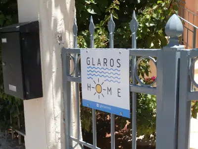 a sign on the gate of a fence at Glaros Home in Kato Daratso
