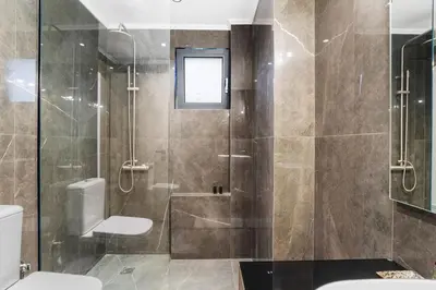 a bathroom with a shower and a toilet at Elan Stay in Chania Town