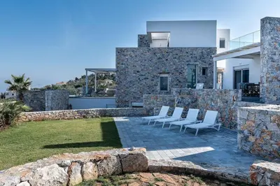 a group of chairs sitting on top of a house at Aloni Villa with pool Kefalas in Vamos
